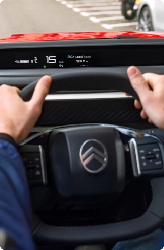Vue intérieure du cockpit de la Citroën ë-C3 Van, mettant en avant le volant multifonctions et les commandes centrées sur le conducteur.