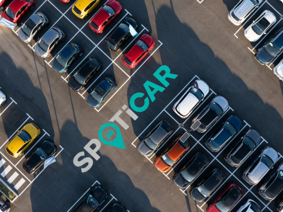 Vue aérienne d’un parking Spoticar présentant plusieurs véhicules d’occasion garés en rangées.